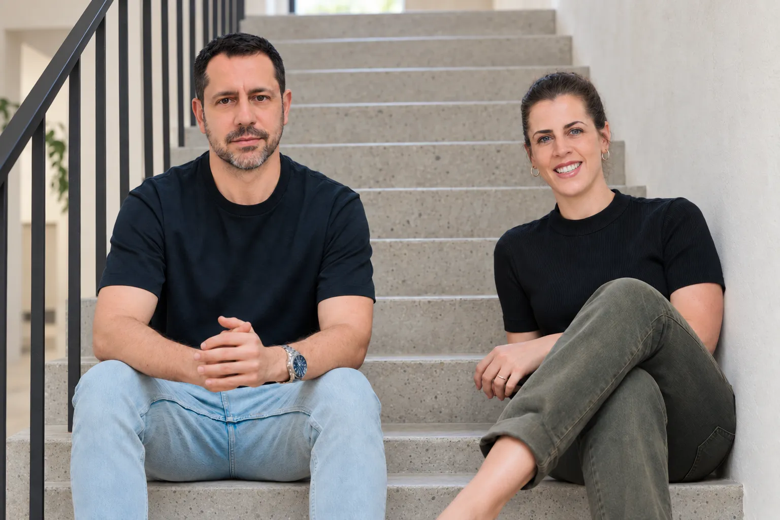 YieldBI founders Robbie Atar and Keren Golan Doron sitting together on a staircase